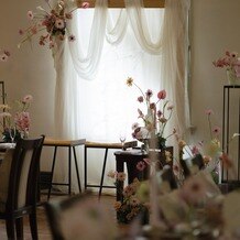 ティアラ・ザ クラシッククラブの写真｜こだわった高砂の装花！タペストリーは自分たちで作り薄めの布をかけて、文字が透けるようにしました