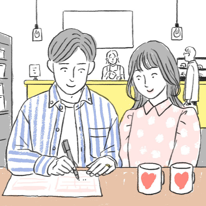 婚姻届の記入をしているカップル